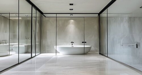 A modern bathroom with a frameless glass shower enclosure featuring a photocatalytic self-cleaning coating. The floor is polished porcelain tile in a large format, and the ceiling is smooth white plas