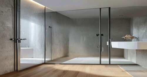 Photorealistic image of a modern bathroom with microcement walls and floating laminate floor, featuring a frameless glass shower enclosure with photocatalytic self-cleaning technology. The glass is pe