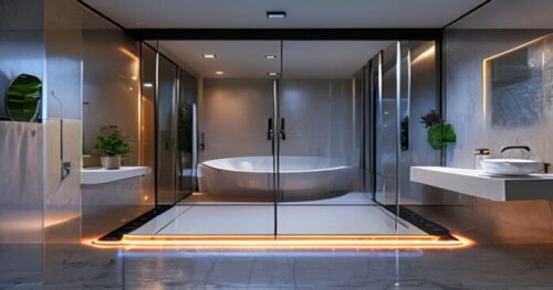 A modern bathroom with a frameless walk-in shower enclosure featuring self-cleaning glass, over a seamless liquid porcelain floor with visible electric radiant heating cables embedded in the subfloor,