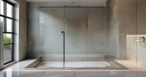 Photorealistic image of a modern bathroom with a frameless glass shower screen installed over a liquid porcelain floor with underfloor heating. The shower screen has a sliding door, no threshold, and