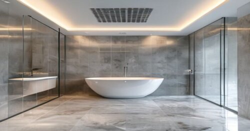 Photorealistic image of a modern bathroom with a glass shower enclosure installed on a seamless liquid porcelain floor. The ceiling is a white plaster false ceiling with a linear ventilation grille in