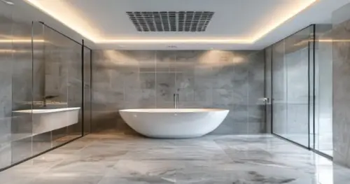 Photorealistic image of a modern bathroom with a glass shower enclosure installed on a seamless liquid porcelain floor. The ceiling is a white plaster false ceiling with a linear ventilation grille in
